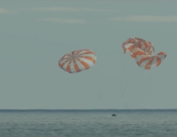 NASA's Orion capsule splashes down in the Pacific Ocean on Sunday.
NASA. (livestream/Screenshot by NPR)