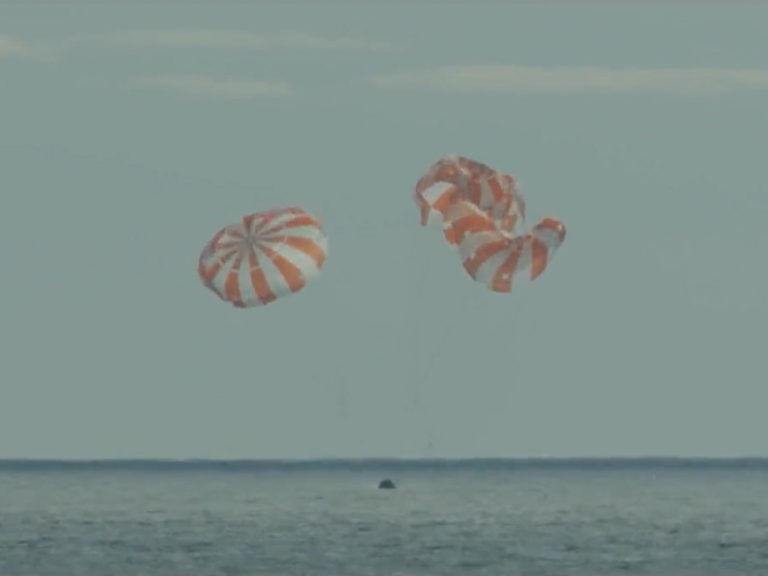 NASA's Orion capsule splashes down in the Pacific Ocean on Sunday.
NASA. (livestream/Screenshot by NPR)