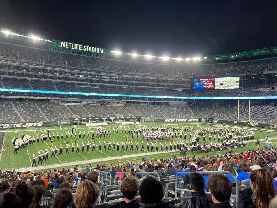 View from the stands of a marching band on a field.
