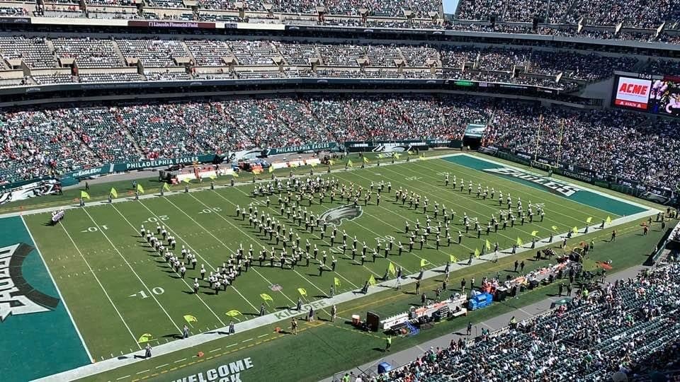 Aerial view of a marching band on a field at an Eagles game.