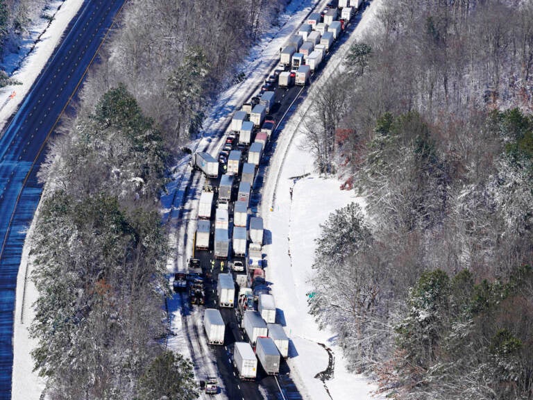 Drivers wait for the traffic to be cleared as cars and trucks are stranded on sections of I-95 after a snow storm.