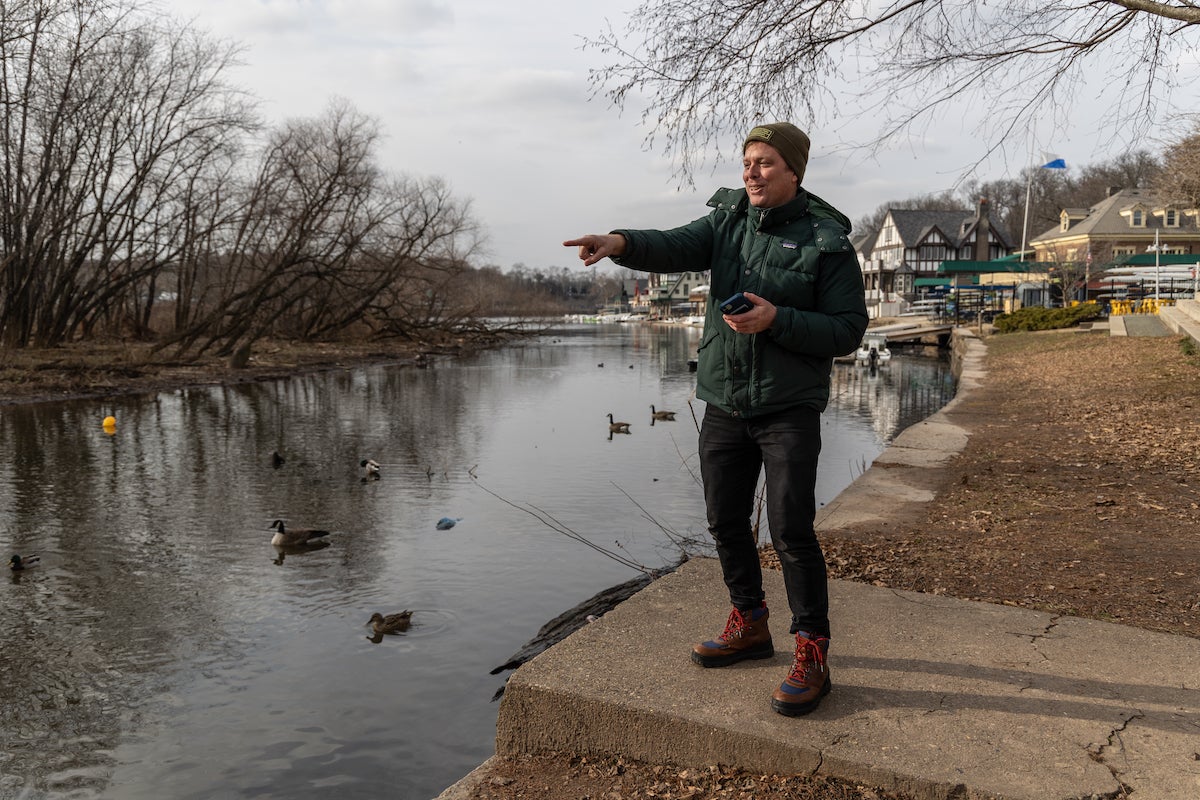 The Fairmount Park Conservancy’s Public Programs Manager John Sigmund demonstrates the fun Philadelphians will have during the organization’s WinTOUR Scavenger Hunt. For six weeks, the public can download the free app and complete the hunt for prizes. (Kimberly Paynter/WHYY)