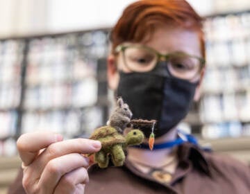 Librarian Alison Miner holds a needle-point felt project she crafted.