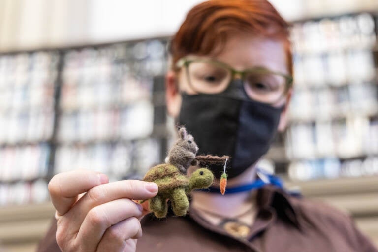 Librarian Alison Miner holds a needle-point felt project she crafted.