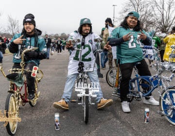 Fan Pedro Cartahgena (left), Victor River (center) and Mauricio Vasquez (right) support the Philadelphia Eagles from the tailgate outside the Linc during the NFC East Championship Game on January 29, 2023. (Kimberly Paynter/WHYY)