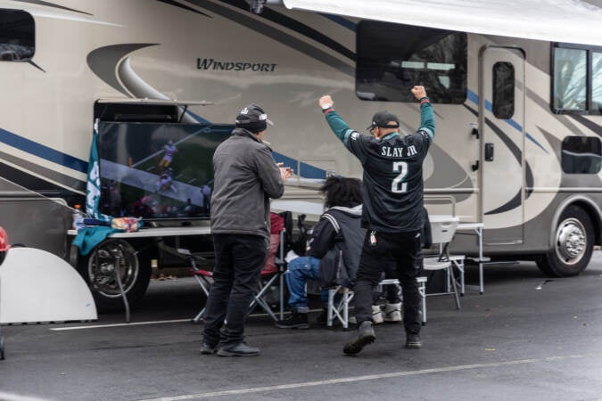 Eagles fans celebrate a touchdown at the tailgate for the NFC East Championship game on January 29, 2023. (Kimberly Paynter/WHYY)