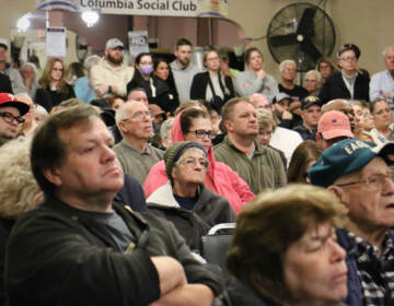 Port Richmond residents crowd into the Columbia Social Club looking for answers about the New Year's Day explosion that destroyed three homes on Miller Street. (Emma Lee/WHYY)