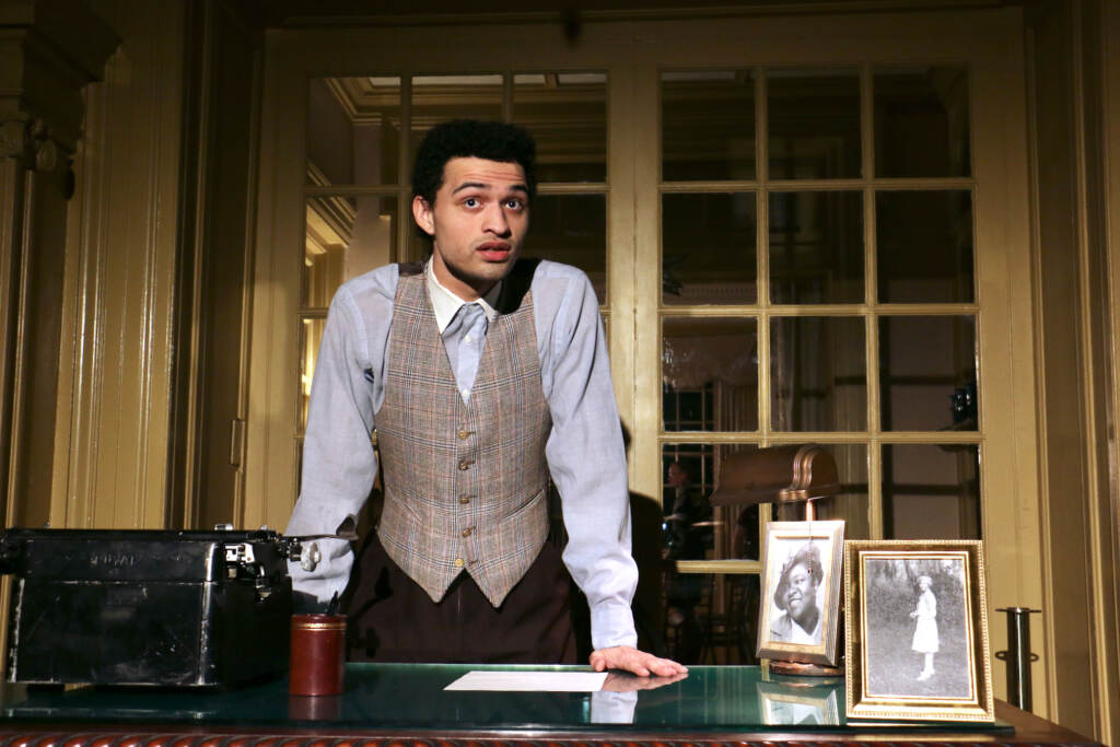 A man stands at a desk.