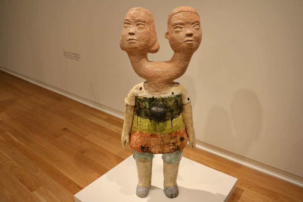 A human figure sculpture with two heads is displayed.