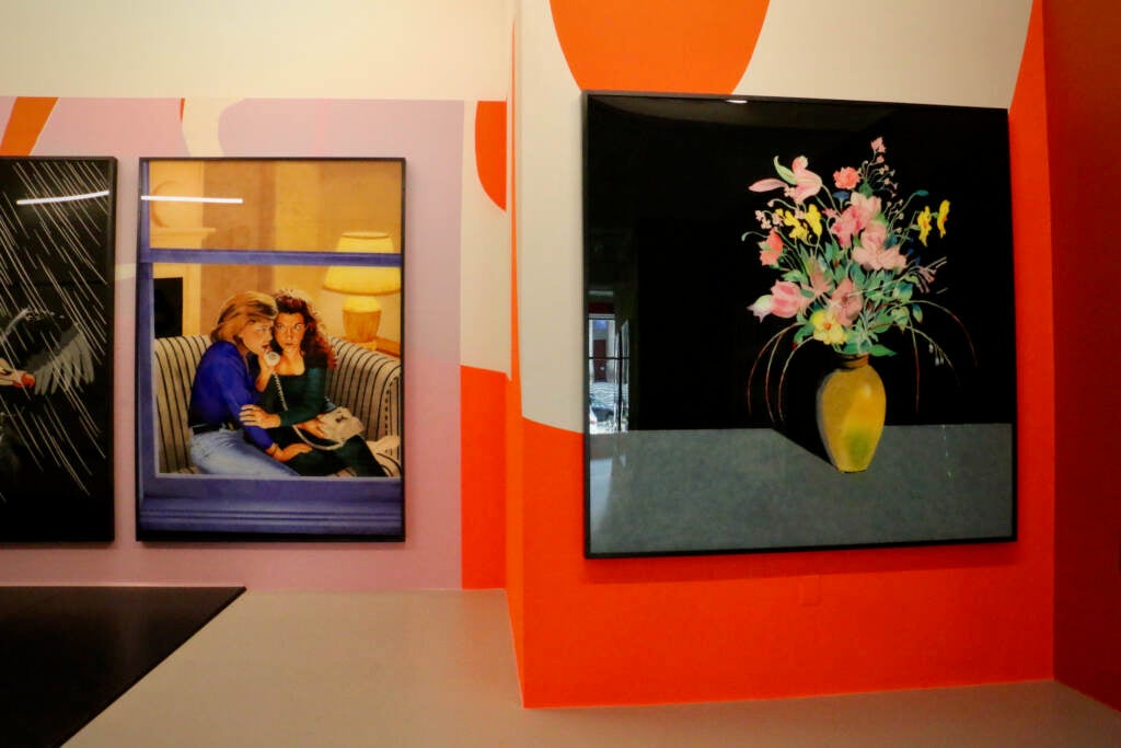 A series of paintings in a brightly-colored gallery space.