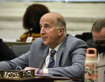 Councilmember Mark Squilla sits at a desk in council chambers.