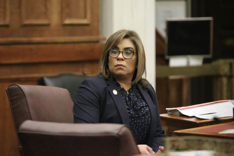 Quetcy Lozada looks out on council chambers while seated at her desk.