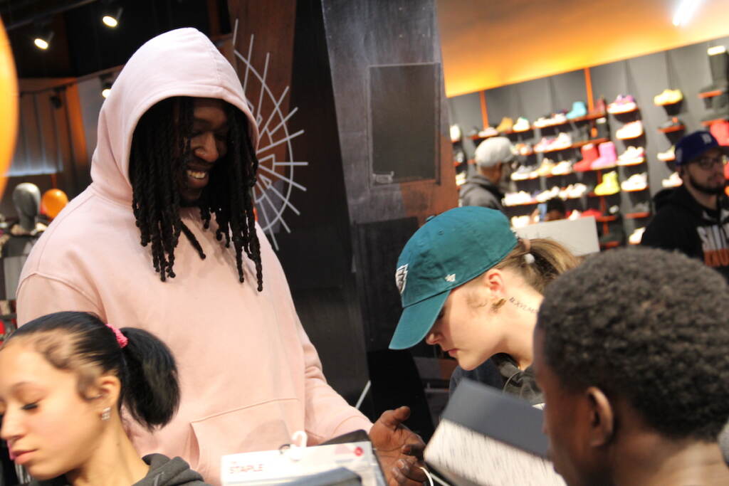 Montrezl Harrell smiles as he stands with a group of kids.