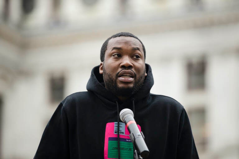 In this April 2, 2019, file photo, rapper Meek Mill speaks at a gathering in Philadelphia to push for drastic changes to Pennsylvania's probation system. Philadelphia's District Attorney's office wants a new trial with a new judge for rapper Meek Mill. Larry Krasner submitted the brief Wednesday, May 22, 2019. He said former Judge Genece Brinkley's court 