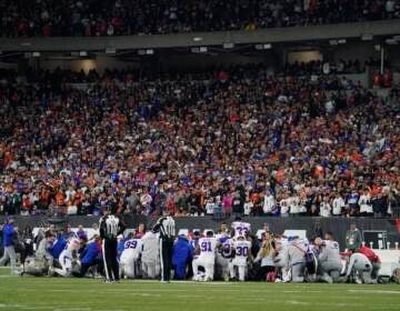 The Buffalo Bills players pray for teammate Damar Hamlin during the first half of an NFL football game against the Cincinnati Bengals, Monday, Jan. 2, 2023, in Cincinnati. (AP Photo/Jeff Dean)