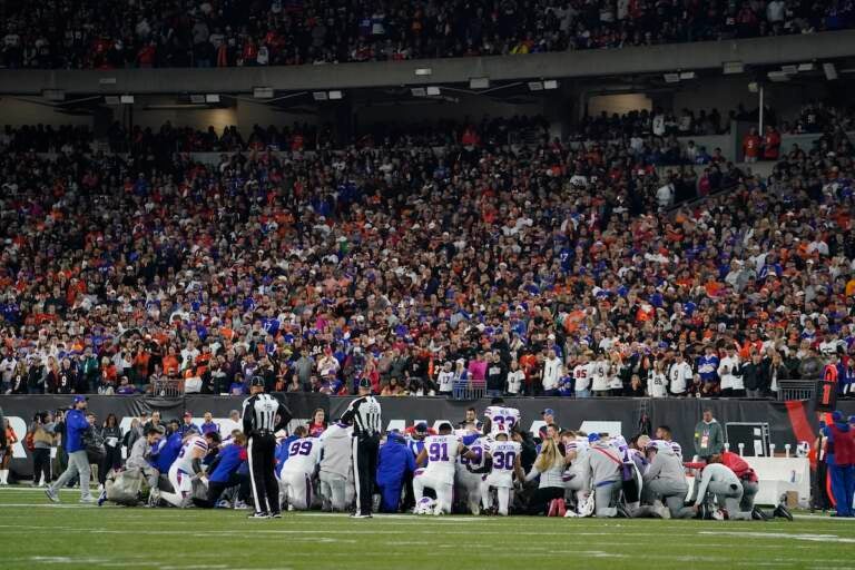 The Buffalo Bills players pray for teammate Damar Hamlin during the first half of an NFL football game against the Cincinnati Bengals, Monday, Jan. 2, 2023, in Cincinnati. (AP Photo/Jeff Dean)