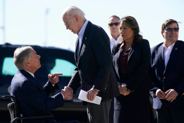 President Joe Biden shakes hands with Texas Gov. Greg Abbott