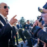 President Joe Biden talks with reporters on the South Lawn of the White House