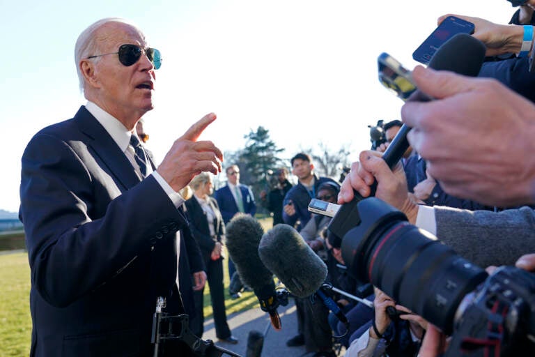 President Joe Biden talks with reporters on the South Lawn of the White House