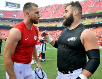 Kansas City Chiefs tight end Travis Kelce, left, talks to his brother, Philadelphia Eagles center Jason Kelce, after they exchanged jerseys following an NFL football game in Kansas City, Mo.