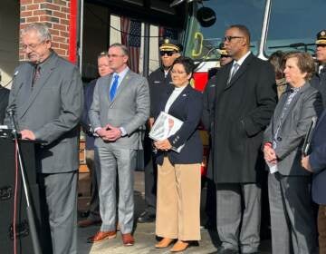 U.S. Fire Administrator Lori Moore-Merrell (center) stands with city officials and representatives of national fire safety organizations at a press event in Philly Wednesday. (Sophia Schmidt/WHYY)