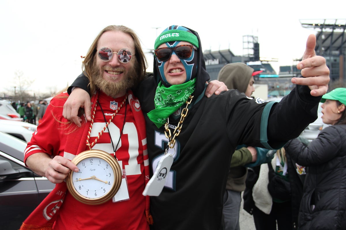 San Francisco 49ers fan Chris Nady (left) and Philadelphia Eagles fan Austin Ritter (right) pose together at a tailgate