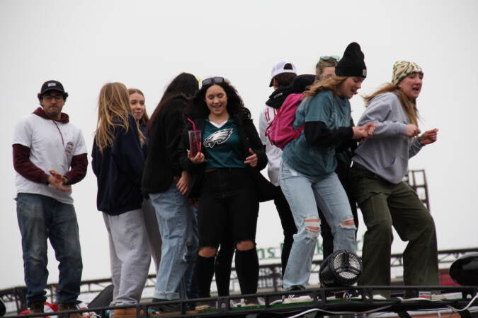 Philadelphia Eagles fans stand and dance on top of a van during the pre-game tailgate at the NFC Championship game