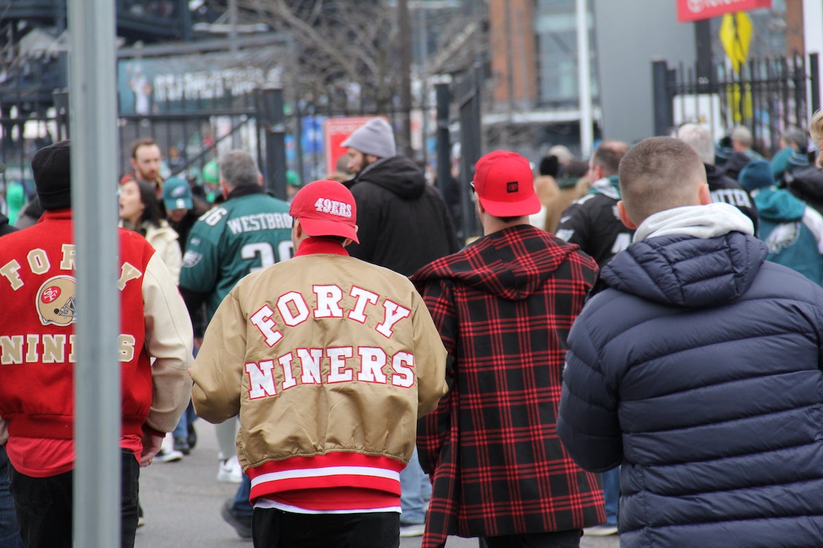 Football fans walk towards Lincoln Financial Field ahead of the NFC Championship game