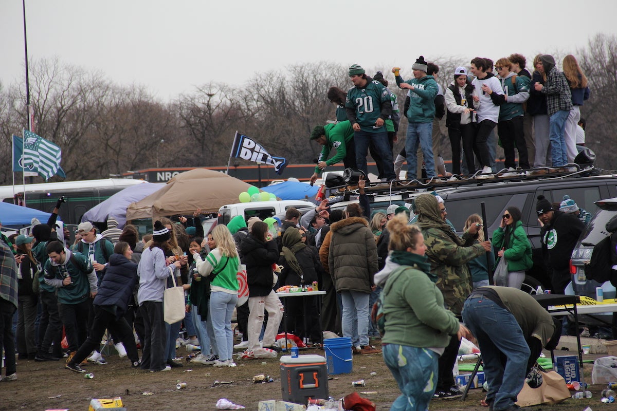 Philadelphia Eagles fans stand around an on top of a van at the tailgate outside of Lincoln Financial Field ahead of the NFC Championship game