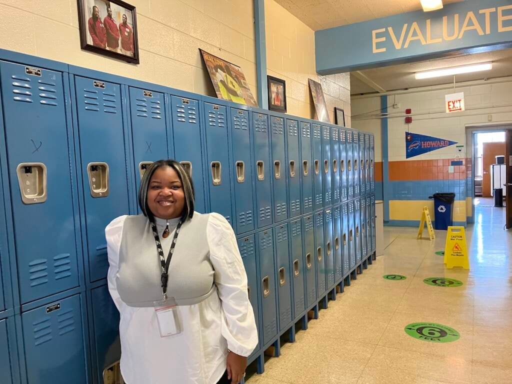 Tiffany Perkins, resource manager with Chicago’s READI program, stands in front of school lockers 