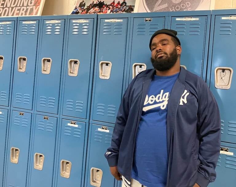 Chicago native Phillip Griffin stands in front of a set of school lockers