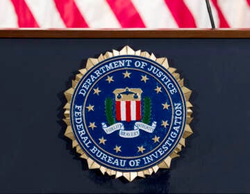 The FBI seal is displayed on a podium.