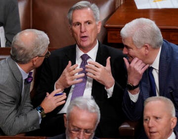 Rep. Kevin McCarthy, R-Calif., is flanked by Rep. Patrick McHenry, R-N.C., left, and Rep. Tom Emmer, R-Minn., right, in the House chamber