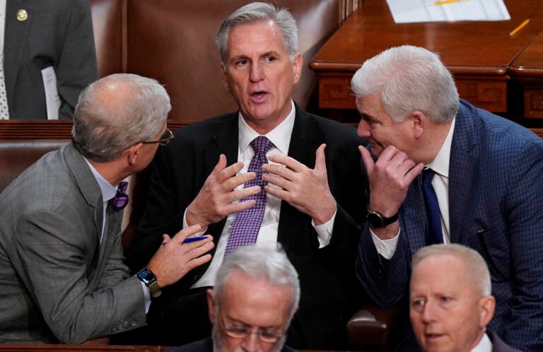 Rep. Kevin McCarthy, R-Calif., is flanked by Rep. Patrick McHenry, R-N.C., left, and Rep. Tom Emmer, R-Minn., right, in the House chamber