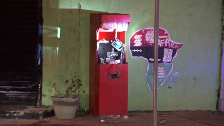 Damaged ATM on the street corner.