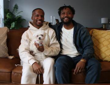 Harry Christian III and Tony Keith Jr sitting in their home.