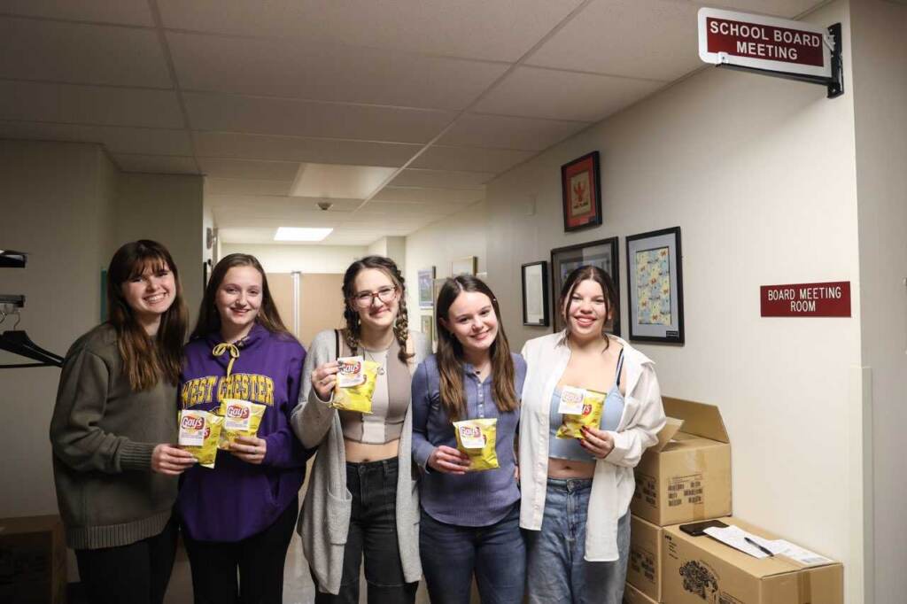 Central Bucks School District high school students Zandi Hall, Ashley Gane, Emma Dickinson, Madyson Szczypiorski, and Skylar Ginsberg stand with bags of Lays chips modified to say ''Gays''