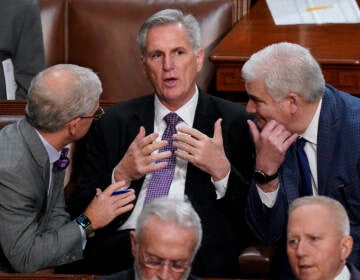 Rep. Patrick McHenry, R-N.C., left, and Rep. Tom Emmer, R-Minn., right, speaks with Rep. Kevin McCarthy, R-Calif., in the House chamber as the House meets for a second day to elect a speaker and convene the 118th Congress in Washington, Wednesday, Jan. 4, 2023. (AP Photo/Alex Brandon)