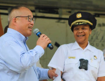 David Oh with 16th District Police Captain Chanta Herder at an August 2022 event discussing relationships between first responders and communities. (Cory Sharber/WHYY)