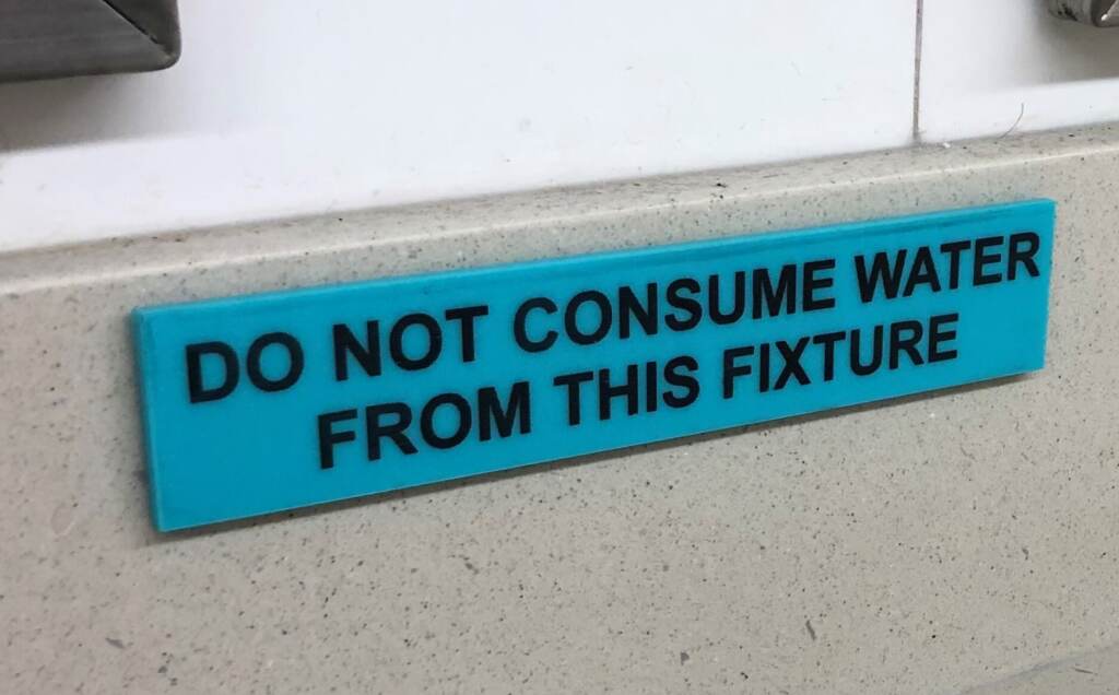 A sign says ''Do not consume water from this fixture''