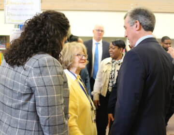 Gov. Carney speaks with two other people.