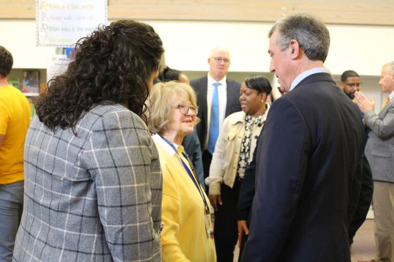 Gov. Carney speaks with two other people.