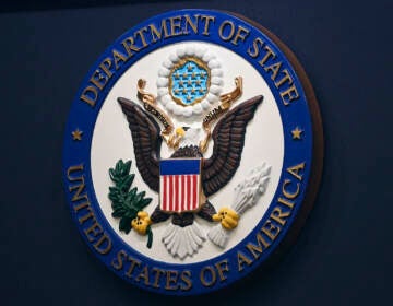 FILE - The State Department seal is seen on the briefing room lectern at the State Department in Washington, Jan. 31, 2022. Everyday Americans will be able to help refugees adjust to life in the U.S. in a program being launched by the State Department. The goal is to give private citizens a role in resettling the thousands of refugees who come to America every year. The State Department is calling the new program the Welcome Corps.(Mandel Ngan, Pool via AP, File)