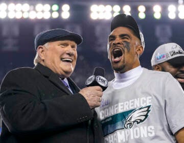 Philadelphia Eagles quarterback Jalen Hurts, center, reacts while speaking toTerry Bradshaw, left, after the NFC Championship NFL football game between the Philadelphia Eagles and the San Francisco 49ers on Sunday, Jan. 29, 2023, in Philadelphia. The Eagles won 31-7. (AP Photo/Matt Slocum)