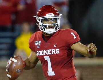 Jalen Hurts prepares to throw a football.