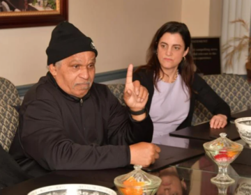 Former Philly Mayor John Street gestures while sitting next to Philly mayoral candidate Rebecca Rhynhart