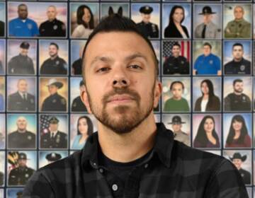 A photo of a man in front of a series of other portraits in the background.