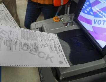 A ballot is fed into a voting machine.