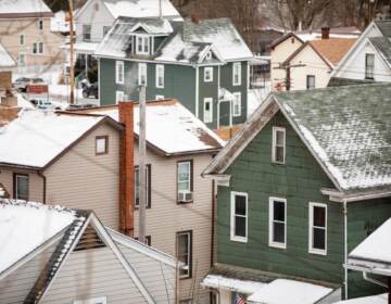 An overview of several houses covered in snow.