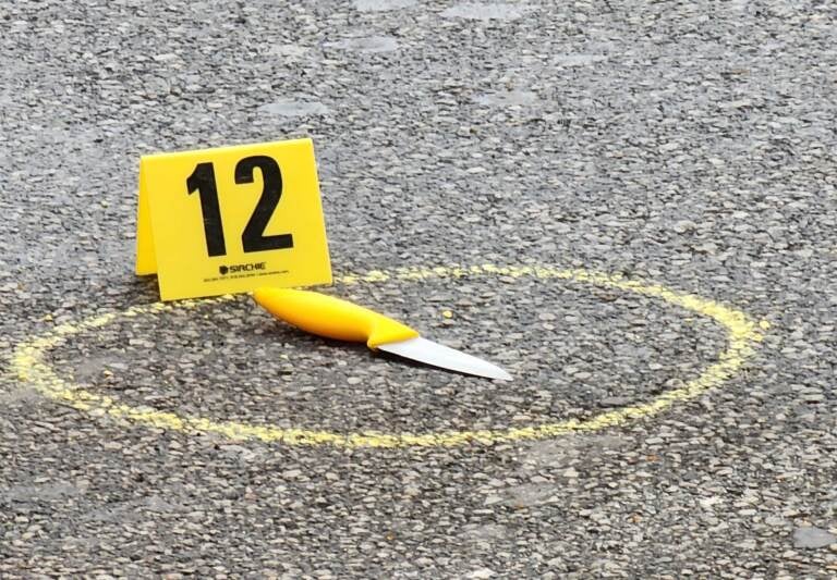 An evidence marker is seen beside a knife outside Philadelphia City Hall